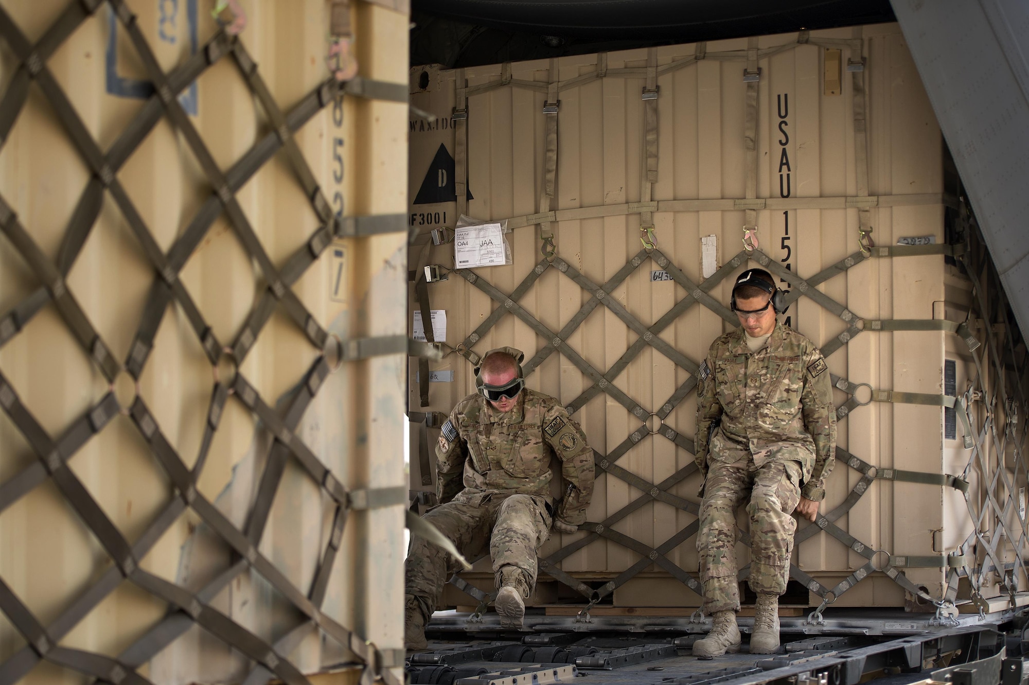 Senior Airman Matthew Hunter and Tech. Sgt. Jonnedi Paule, 19th Movement Control Team aerial porters, heft a "tricon" shipping container into a C-130 Hercules cargo plane at Forward Operating Base Salerno, Khost province, Afghanistan, Sept. 21, 2013. The 19th MCT, a small squadron of Air Force surface movement controllers and aerial porters, have the herculean task of overseeing the vast majority of retrograde operations at FOB Salerno. Hunter and Paule are both forward deployed from Travis Air Force Base, Calif.
