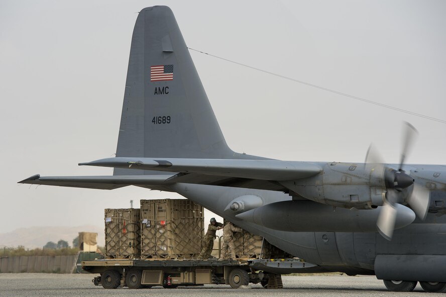 A loadmaster from the 774th Expeditionary Air Lift Squadron and aerial porters from the 19th Movement Control Team, roll a "tricon" shipping container into a C-130 Hercules cargo plane at Forward Operating Base Salerno, Khost Province, Afghanistan, Sep. 21, 2013. The 19th MCT, a small squadron of Air Force surface movement controllers and aerial porters, have the herculean task of overseeing the vast majority of retrograde operations at FOB Salerno.
