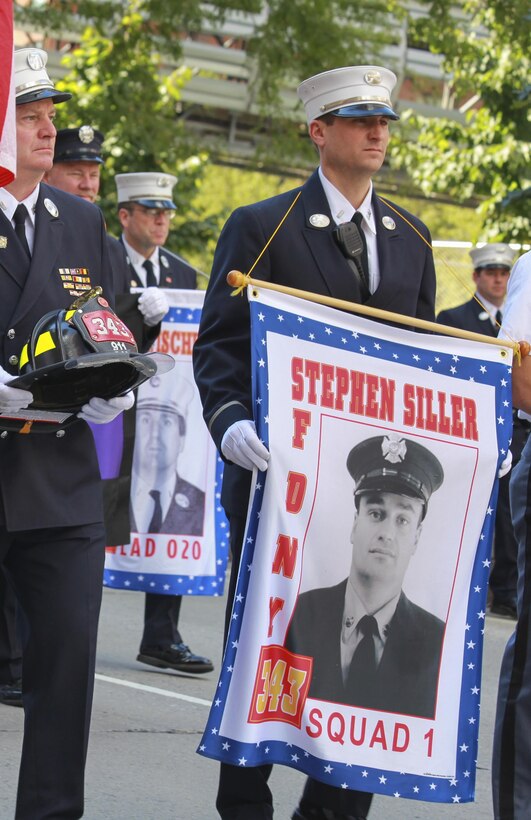 A firefighter from the New York City Fire Department carries a banner honoring firefighter Stephen Siller during the Tunnel to Towers run in Manhattan Sept. 29.  Tunnel to Towers, a 5-kilometer run, is held annually in honor of Siller, who ran to the World Trade Center through the Battery Tunnel with all his gear on during the attacks on 9/11, ultimately losing his life during his attempt to save others.  (U.S. Marine Corps photo by Sgt. Caleb Gomez).