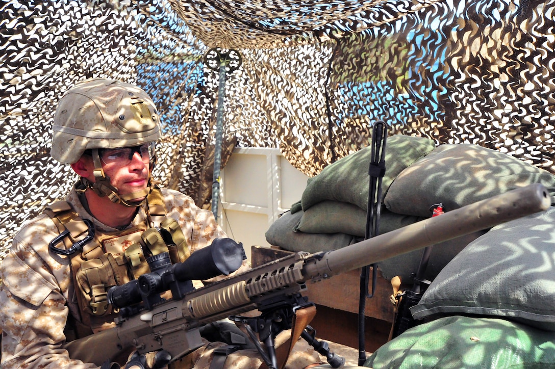 Lance Cpl. Jaycob Riggins sits behind a M110 Semi-Automatic Sniper System during a training exercise aboard Marine Corps Base Quantico. Riggins is part of a Marine Fleet Antiterrorism Security Team who spent a week training on the base. (Marine Corps photo by Lance Cpl. Samuel Ellis/ Released)