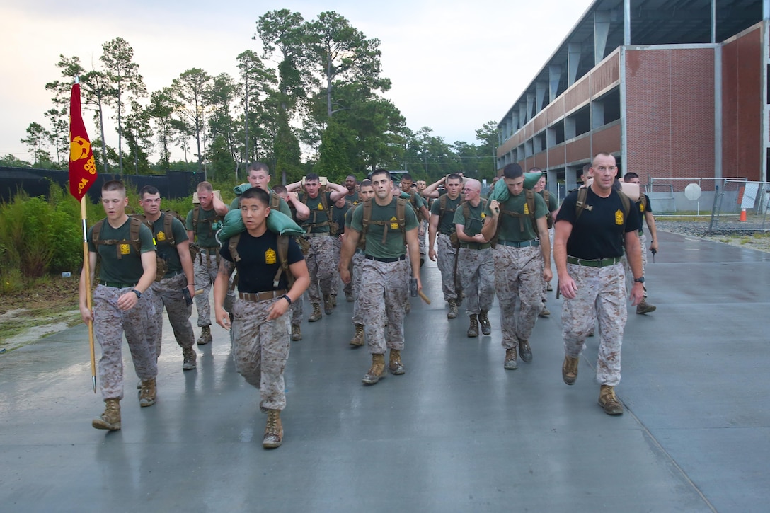 Corporals with 2nd Assault Amphibian Battalion, 2nd Marine Division, follow as Sgt. Maj. Brett C. Scheuer, the battalion sergeant major leads from the front during the motivational hike for the battalion’s corporal’s course aboard Marine Corps Base Camp Lejeune Sept. 26, 2013. “I am very proud of the corporals,” Scheuer said. “They have exceeded my expectations and the lieutenant colonel’s expectations.”