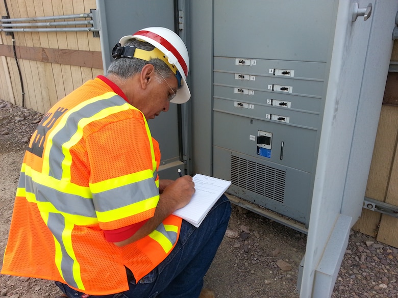 USACE Mehrbad Golshani, an electrical engineer with the Los Angeles District, inspects an electrical panel at this Fort Irwin Office. 
The Los Angeles District sent a team of more than 70 engineering and technical support professionals to the fort to assess damage and provide recovery operations after flooding from a monsoon-like storm covered the post with mud and debris Aug. 25.