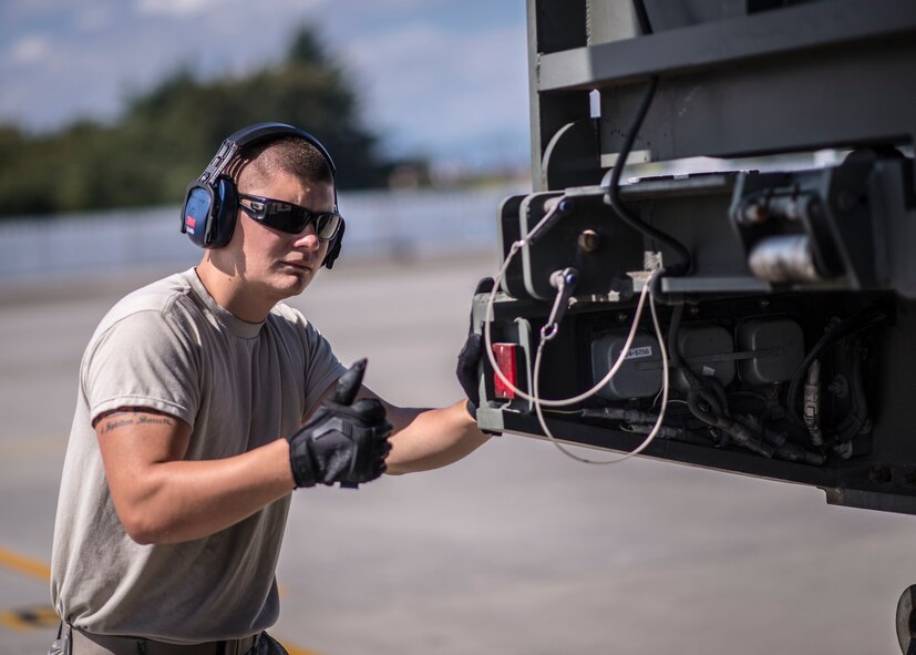 An Airman from the 374th Logistics Readiness Squadron observes a Next Generation Small Loader as it is loaded aboard a C-130 Hercules during a training session at Yokota Air Base, Japan, Sept. 30, 2013. As the Western Pacific mobility hub, Yokota is postured to transport people and equipment throughout the region in support of contingency operations. (U.S. Air Force photo by Captain Raymond P. Geoffroy/Released)