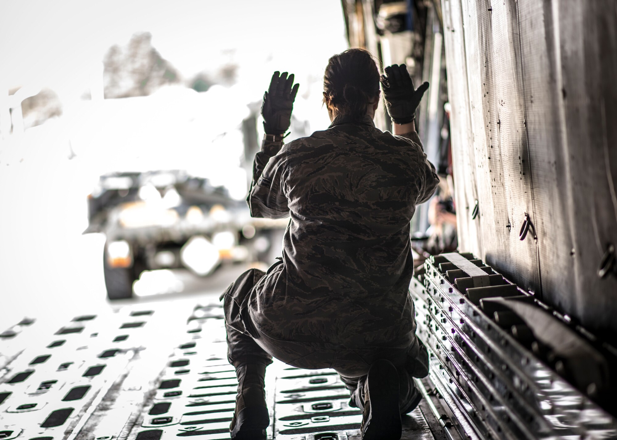 Airman 1st Class Janice Ebeling, 36th Airlift Squadron loadmaster, marshals a Next Generation Small Loader aboard a C-130 Hercules during a training session at Yokota Air Base, Japan, Sept. 30, 2013. As the Western Pacific mobility hub, Yokota is postured to transport people and equipment throughout the region in support of contingency operations. (U.S. Air Force photo by Captain Raymond P. Geoffroy/Released)