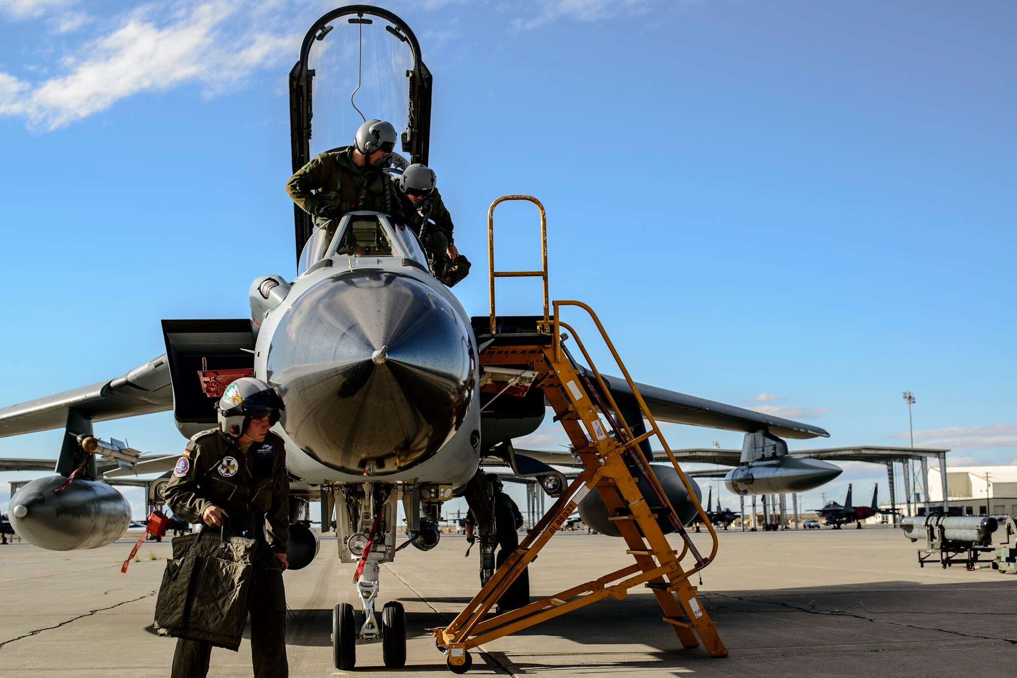 A German Air Force crew chief accomplishes post-flight checks as pilots disembark their AG-51 Tornado at Mountain Home Air Force Base, Idaho, Sept. 30, 2013. The Tornados will be at Mountain Home from Sept. 30 through Oct. 19 for Mountain Roundup 2013, an exercise that is part of the German Air Force Tornado Fighter Weapons Instructor Course Mission Employment (ME) Phase. (U.S. Air Force photo by Master Sgt. Kevin Wallace/RELEASED)