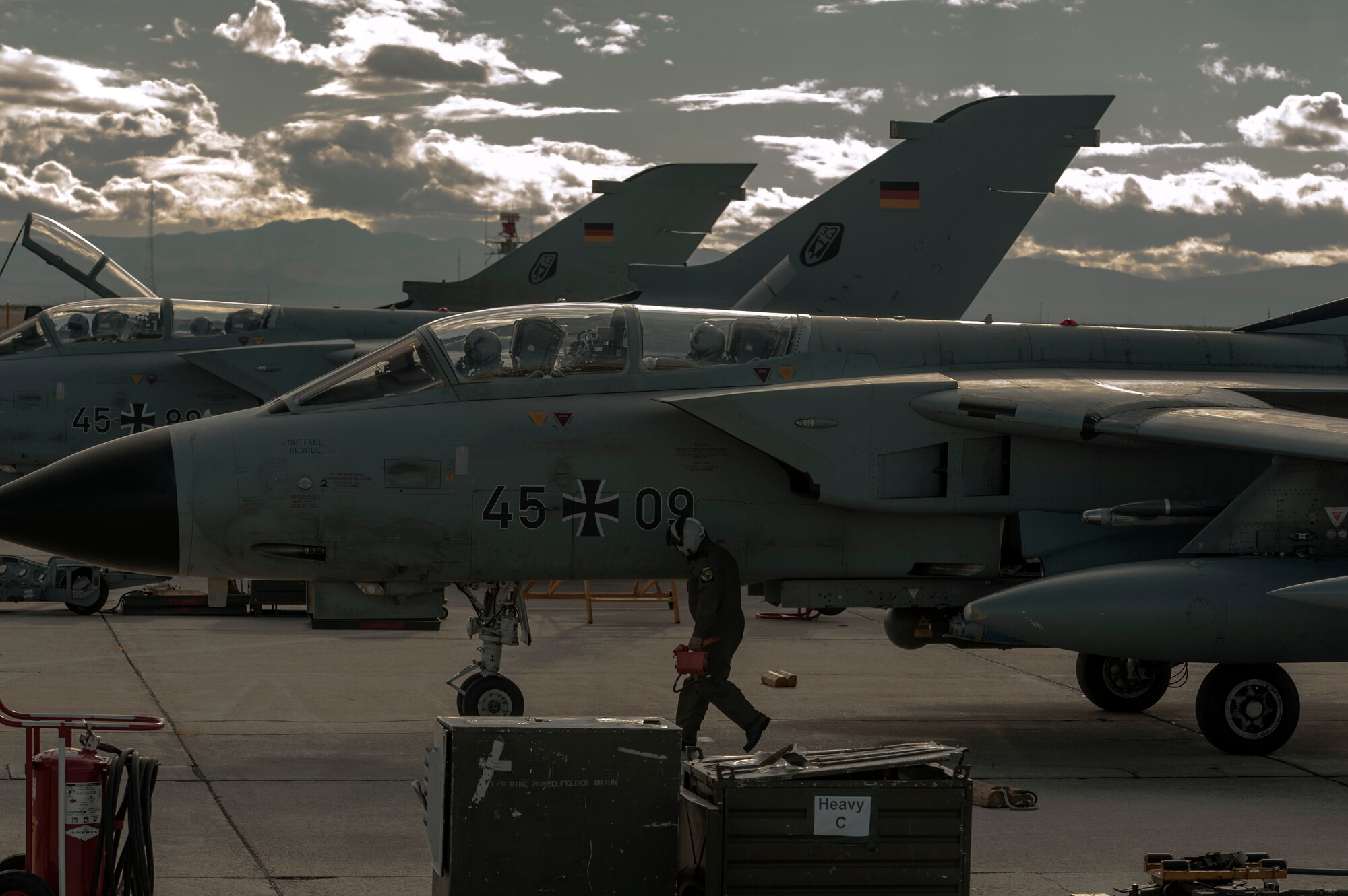 German crew chiefs prepare for post-flight checks as four AG-51 Tornados land at Mountain Home Air Force Base, Idaho, Sept. 30, 2013. The Tornados will be at Mountain Home from Sept. 30 through Oct. 19 for Mountain Roundup 2013, an exercise that is part of the German Air Force Tornado Fighter Weapons Instructor Course Mission Employment (ME) Phase. (U.S. Air Force photo by Master Sgt. Kevin Wallace/RELEASED)