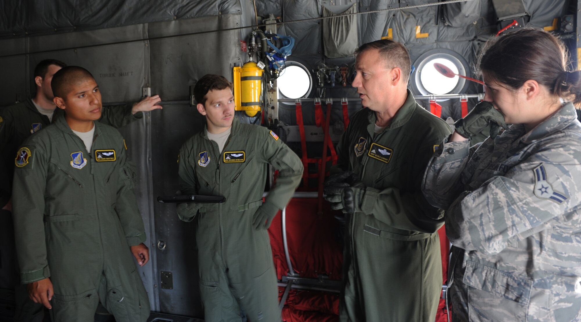Center right, Chief Master Sgt. Reynold Albright, 36th Airlift Squadron loadmaster, talks about loading operations during training at Yokota Air Base, Japan, Sept. 30, 2013. In conjunction with the 374th Logistics Readiness Squadron, the 36 AS practiced loading a Next Generation Small Loader onto a C-130 Hercules through multiple scenarios. (U.S. Air Force photo by Senior Airman Desiree Economides/Released)