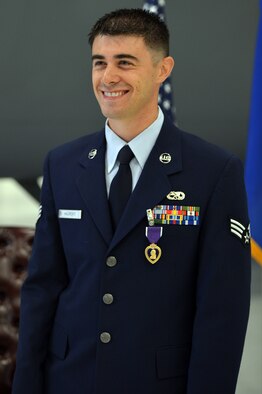 Senior Airmen Anthony Haupert, 62nd Aircraft Maintenance Squadron communications and navigation systems specialist, smiles as honored guests congratulate him for his award of the Purple Heart medal, Sept. 27, 2013, at Joint Base Lewis-McChord, Wash. Haupert’s wife, daughter, mother and father were among the honored guests at the ceremony. (U.S. Air Force photo/Staff Sgt. Jason Truskowski)