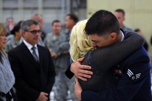 Senior Airmen Anthony Haupert, 62nd Aircraft Maintenance Squadron communications and navigation systems specialist, hugs his wife after receiving the Purple Heart medal at a ceremony, Sept. 27, 2013, at Joint Base Lewis-McChord, Wash. Haupert received the medal for wounds received in action, Aug. 22, 2012. (U.S. Air Force photo/Staff Sgt. Jason Truskowski)