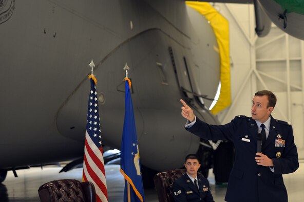 Col. Craig Gaddis, 62nd Maintenance Group commander, points to eight patchwork sections on a battle-damaged C-17 Globemaster III aircraft during a Purple Heart medal presentation ceremony, Sept. 27, 2013, at Joint Base Lewis-McChord, Wash. The C-17 was used as cover for retreating Airmen during an attack in Afghanistan in 2012. (U.S. Air Force photo/Staff Sgt. Jason Truskowski)