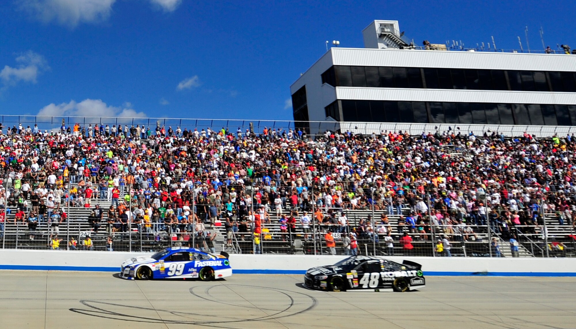 Carl Edwards, driver of the No. 99 Fastenal Ford and Jimmie Johnson, driver of the No. 48 Kobalt Chevy, race into turn one during the AAA 400 Sept. 29, 2013, at Dover International Speedway in Dover, Del. Johnson won at Dover for a record-breaking eighth time. (U.S. Air Force photo/Tech. Sgt. Chuck Walker)