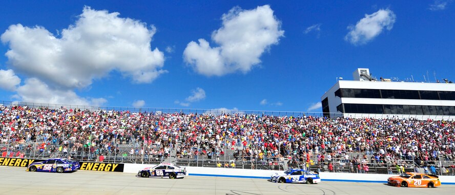 Drivers race into turn one during the AAA 400 Sept. 29, 2013, at Dover International Speedway in Dover, Del. Jimmie Johnson, driver of the No. 48 Kobalt Chevy, won at Dover for a record-breaking eighth time. (U.S. Air Force photo/Tech. Sgt. Chuck Walker)