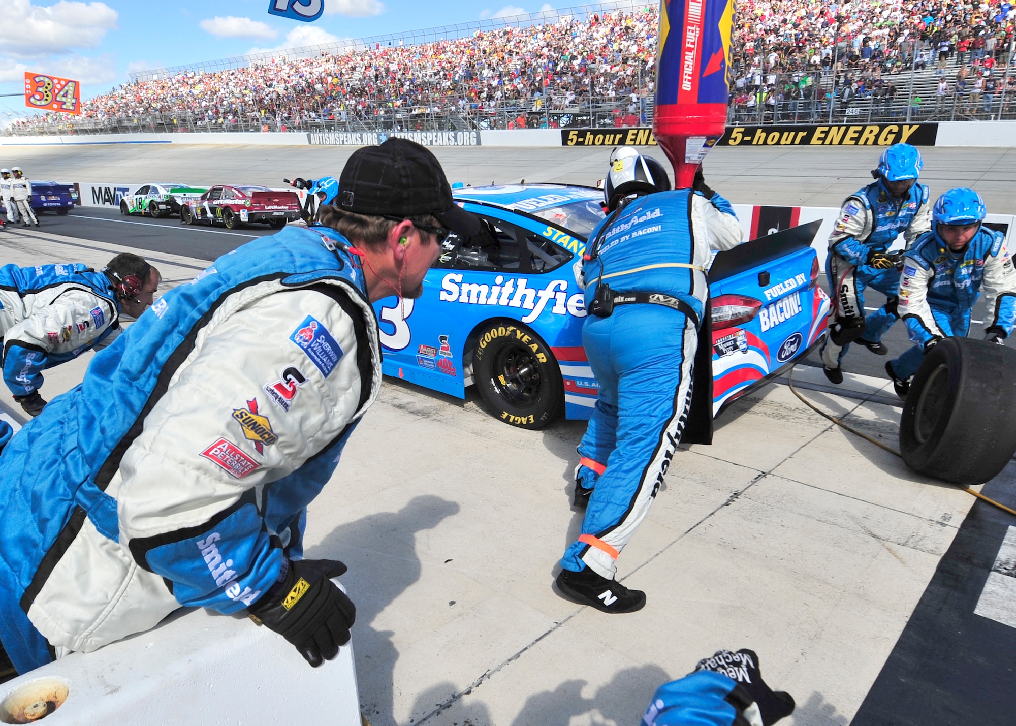 Pit-crew members for Aric Almirola, driver of the No. 43 Smithfield/U.S. Air Force Ford, work on his car during the AAA 400 Sept. 29, 2013, at Dover International Speedway in Dover, Del. Almirola was pitting under a caution for debris on the track. (U.S. Air Force photo/Tech. Sgt. Chuck Walker)