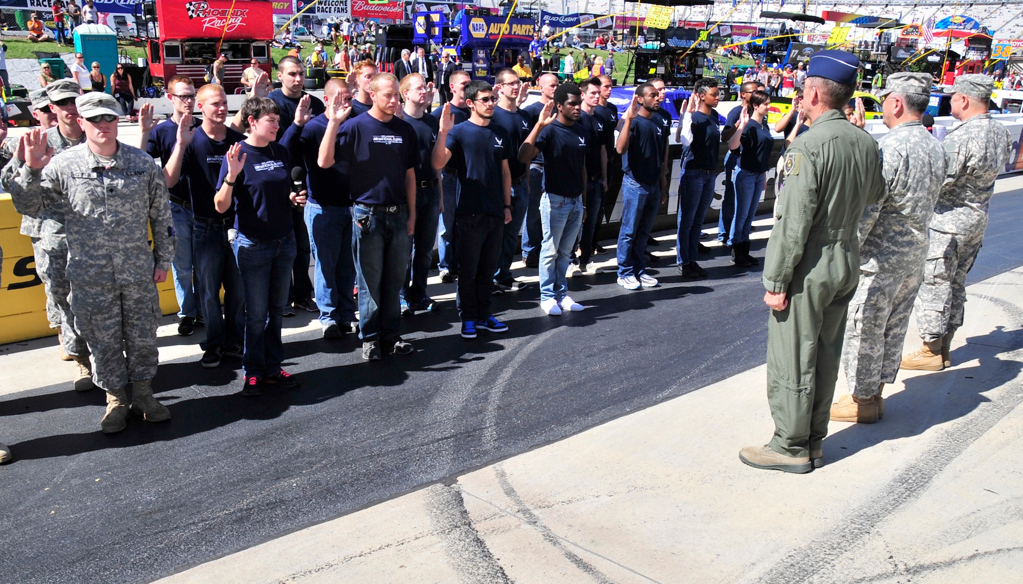 New enlistees take the Oath of Enlistment during pre-race festivities before the AAA 400 Sept. 29, 2013, at Dover International Speedway in Dover, Del. The new enlistees joined the U.S. Air Force, U.S. Air Force Reserve, Delaware National Guard and Delaware Air National Guard. (U.S. Air Force photo/Tech. Sgt. Chuck Walker)