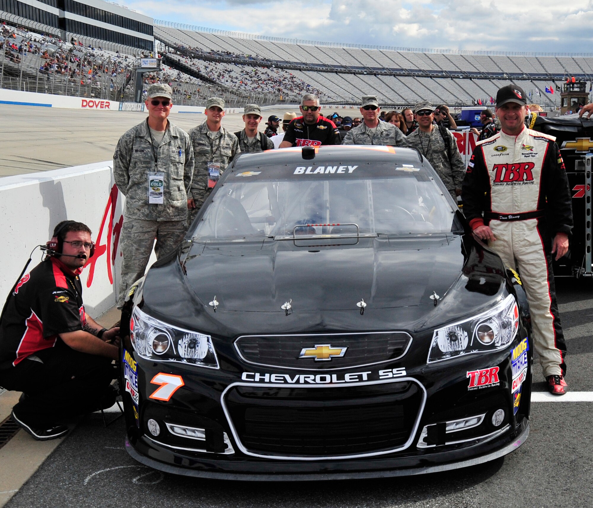 Dave Blaney, driver of the No. 7 Tommy Baldwin Racing Chevy, poses with honorary pit crew members from Dover Air Force Base prior to qualifying Sept. 27, 2013, at Dover International Speedway in Dover, Del. Blaney started the AAA 400 from the 40th position and finished the race in 33rd. (U.S. Air Force photo/Tech. Sgt. Chuck Walker)
