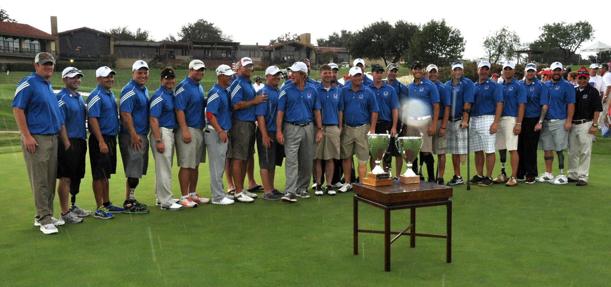 During the closing ceremonies at Las Collinas Country Country Club Golf Course, President Bush presented the Champion's Cup to Corporal Chad Pfeifer and the Warrior Cup to Staff Sargeant Benjamin Dellinger and Captain Matthew Anderson ending the 2013 Warrior Open and just before it poured rain. Eighteen wounded warriors from the Air Force, Army and Marines joined in a competitive two-day, 36-hole golf tournament that kicked off Sept. 26, 2013, to honor post-9/11 U.S. service members wounded in the global war on terror. (U.S. Air Force photo/MSgt Julie Briden-Garcia)