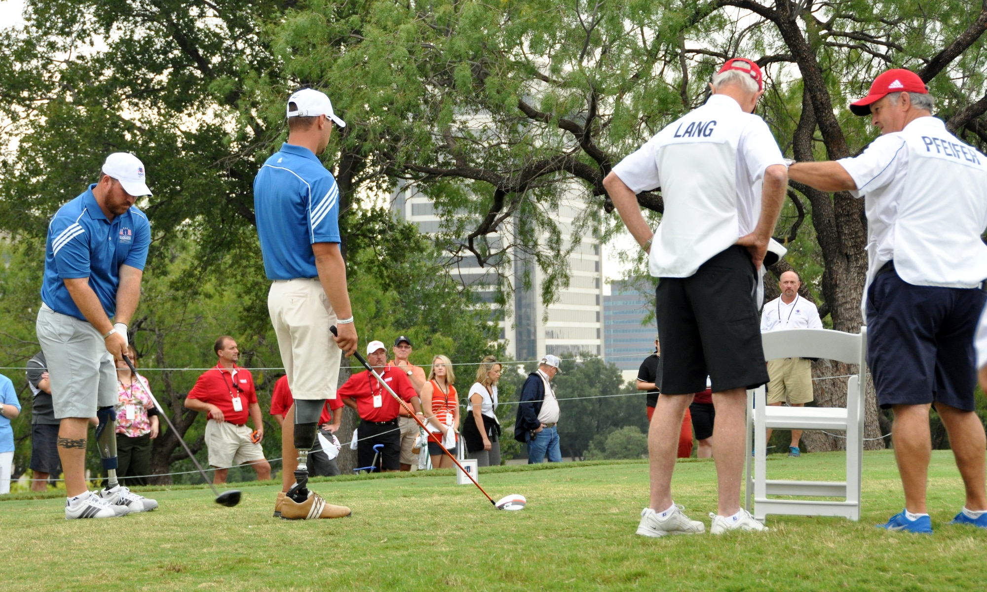 U.S. Marine Sgt. Tim Lang and his partner await their turn to tee off on the final day of the Bush Center Warrior Open held at the Las Colinas Country Club Golf Course in Irving, Texas. Eighteen wounded warriors from the Air Force, Army and Marines joined in a competitive two-day, 36-hole golf tournament that kicked off Sept. 26, 2013, to honor post-9/11 U.S. service members wounded in the global war on terror. (U.S. Air Force photo/MSgt Julie Briden-Garcia)
