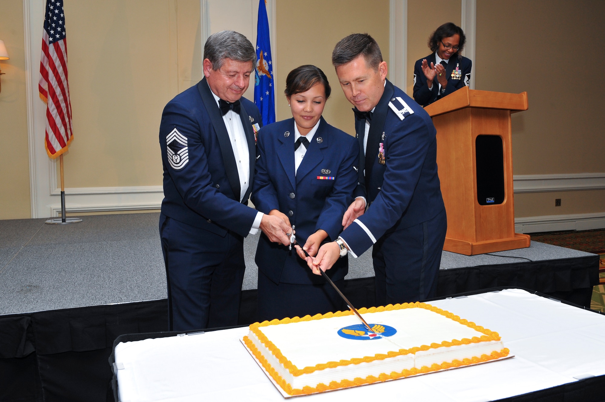 Retired Chief Master Sgt. of the Air Force David J. Campanale, left; Airman Amanda Belarde, 460th Space Wing Legal Office military justice paralegal, center; and Col. Dan Wright, 460th SW commander, cut the Air Force birthday cake during the Air Force Ball Sept. 27, 2013, at the Renaissance Hotel in Denver. This year’s celebration marked the 66th Air Force birthday and paid respects to 1st Lt. John Harold "Buck" Buckley the base’s namesake, who was killed during World War I 95 years ago. (U.S. Air Force photo by Senior Airman Phillip Houk/Released)
