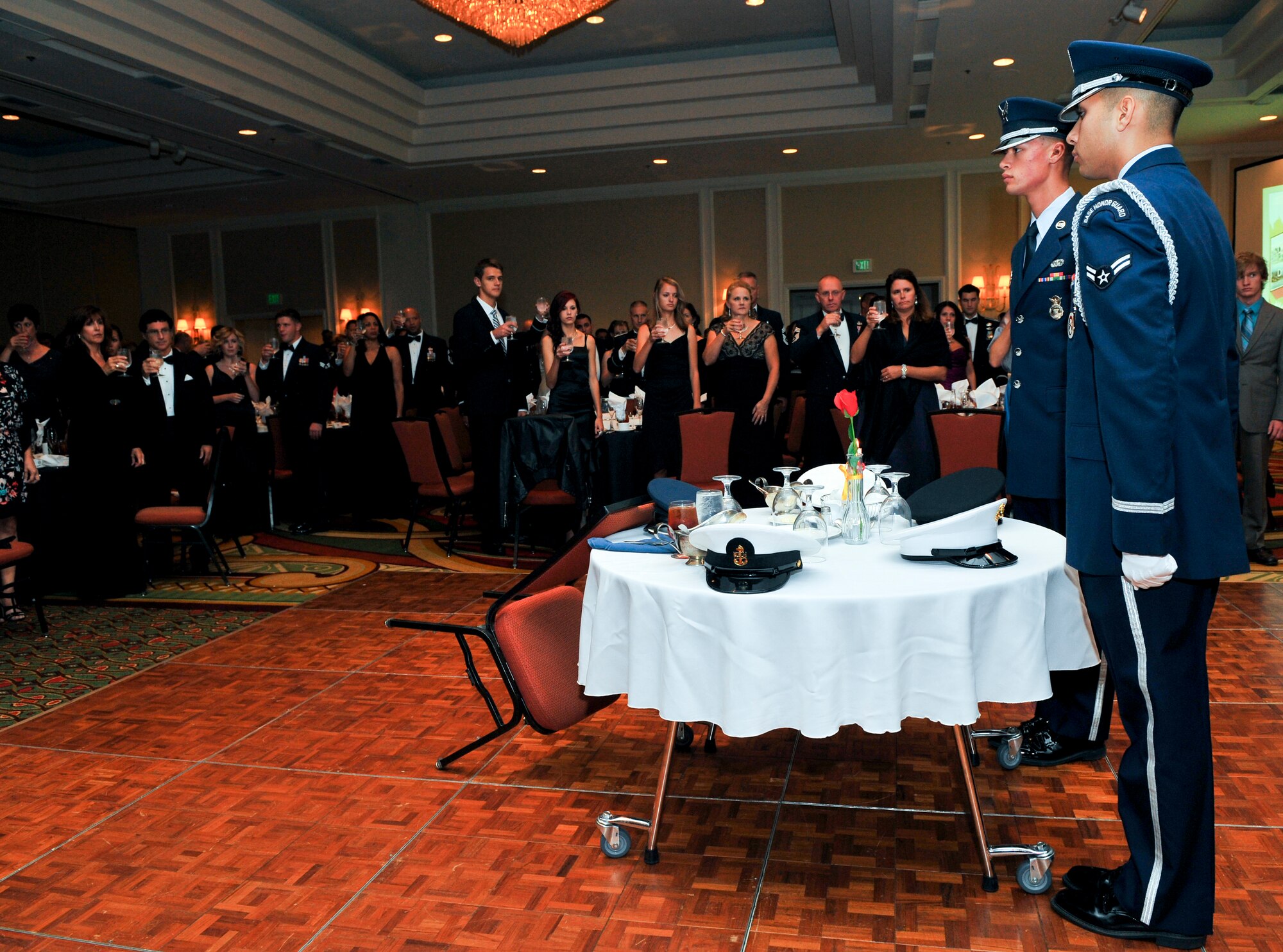 Attendees of the Air Force Ball toast durring a PWO/MIA observance at the Air Force Ball Sept. 27, 2013, at the Renaissance Hotel in Denver. This year’s celebration marked the 66th Air Force birthday and paid respects to 1st Lt. John Harold "Buck" Buckley the base’s namesake, who was killed during World War I 95 years ago. (U.S. Air Force photo by Senior Airman Phillip Houk/Released)