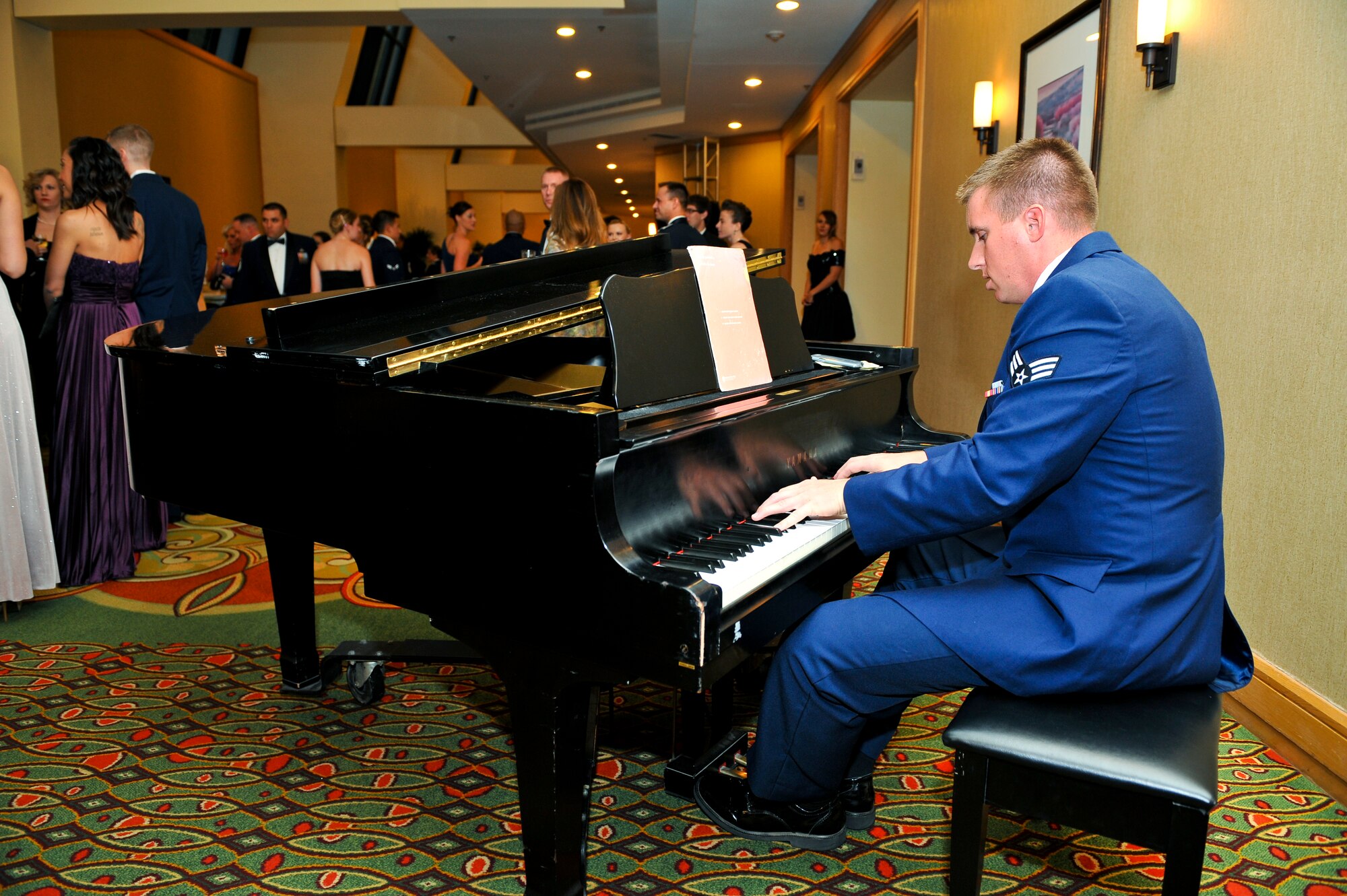 Senior Airman John Schneider, 460th Contracting Squadron, plays the piano for Air Force Ball attendees during social hour Sept. 27, 2013, at the Renaissance Hotel in Denver. This year’s celebration marked the 66th Air Force birthday and paid respects to 1st Lt. John Harold "Buck" Buckley the base’s namesake, who was killed during World War I 95 years ago. (U.S. Air Force photo by Senior Airman Phillip Houk/Released)