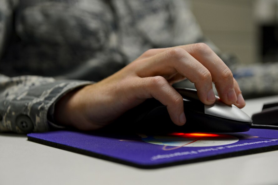 Airman 1st Class Jesse Manley, 2nd Comptroller Squadron accounting technician, works on a computer on Barksdale Air Force Base, La., Sept. 27, 2013. Airmen from the 2nd CPTS worked after normal duty hours for the end of fiscal year 2013 soft closeout. At the end of every fiscal year, money that the Air Force has not spent is gathered and used to support the mission by providing units with essential equipment and services. (U.S. Air Force photo/Senior Airman Micaiah Anthony)   