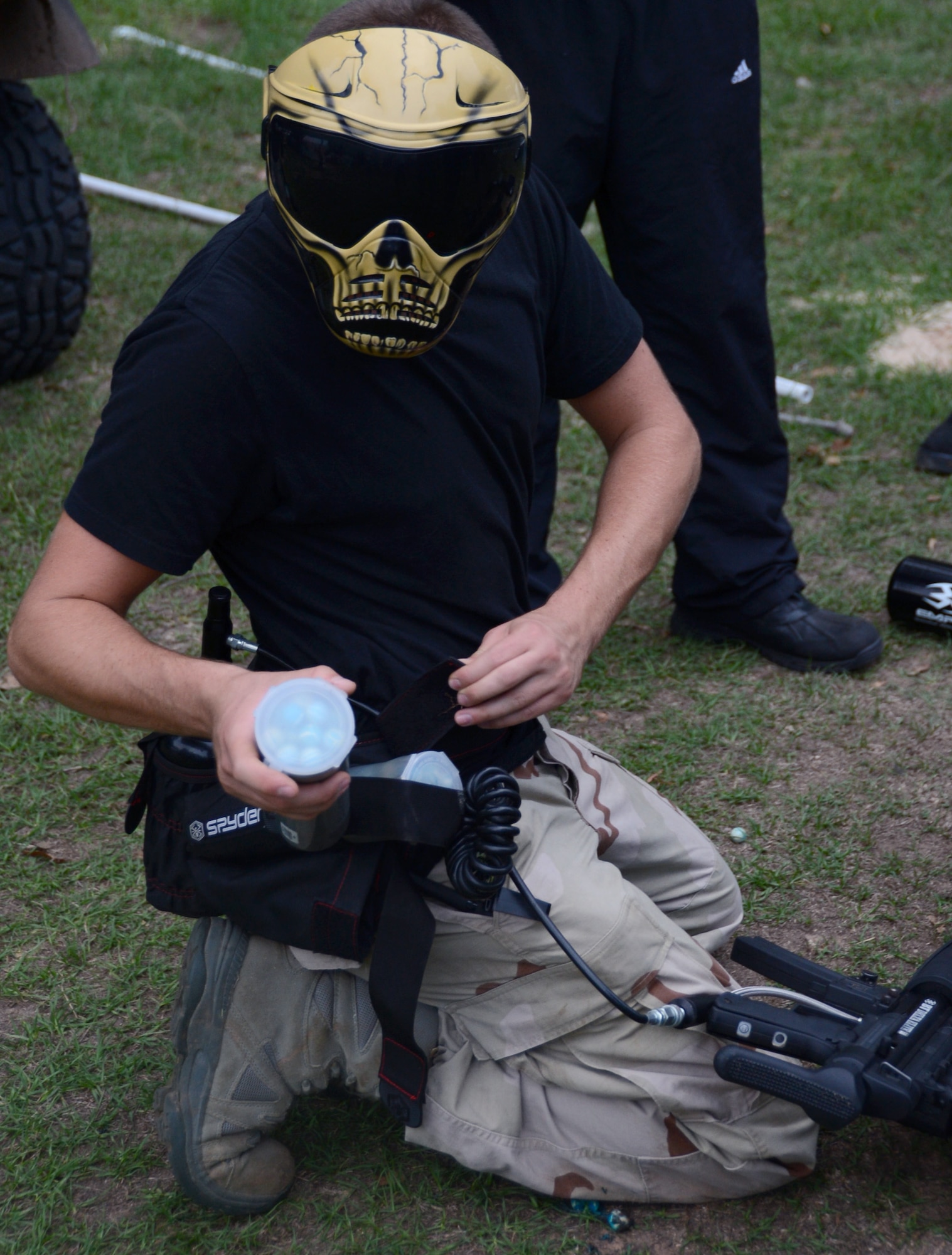 A paintball player prepares canisters of extra paintballs prior to the Zombie Apocalypse paintball game on Barksdale Air Force Base, La., Sept. 28, 2013. The game was held to build camaraderie among Team Barksdale members and Airmen. More than 100 participants played as either zombies or humans. (U.S. Air Force photo/Staff Sgt. Amber Corcoran)