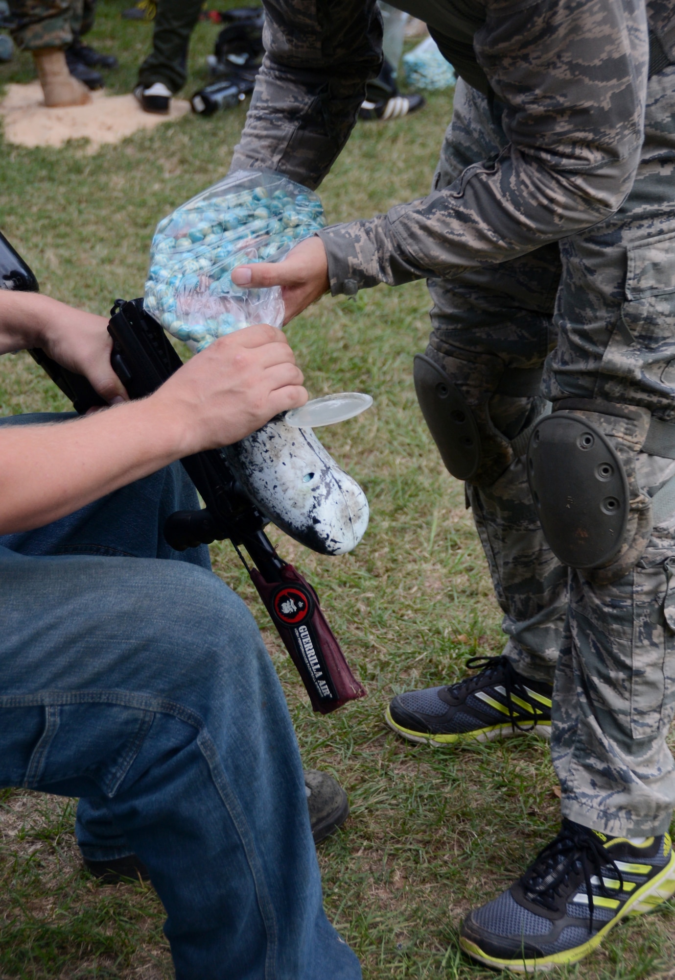 Humans load their weapons with paintballs prior to the Zombie Apocalypse paintball game on Barksdale Air Force Base, La., Sept. 28, 2013. The game, held on the East Reservation on base, pitted teams of humans against oncoming waves of zombies. (U.S. Air Force photo/Staff Sgt. Amber Corcoran)