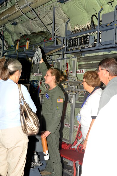 2nd Lt. Leesa Froelich, an aerial reconnaissance weather officer with the 53rd Weather Reconnaissance Squadron, demonstrates to members of the Ninety Nines how the dropsonde looks after exiting the WC-130J into a hurricane, tropical storm or tropical depression during their visit to the 53rd WRS.  The Ninety Nines were given a tour to further educate the pilots on weather reconnaissance.  (U.S. Air Force Photo by Tech. Sgt. Jessica L. Kendziorek)