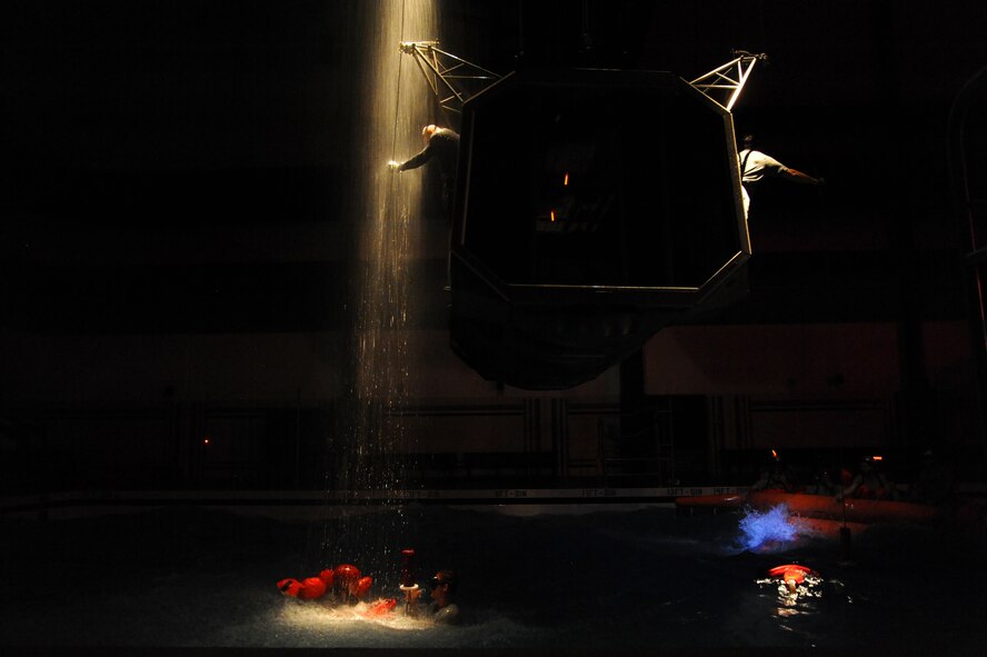 U.S. Air Force's Survival, Evasion, Resistance and Escape instructors train students in water survival scenarios in the Fairchild AFB aquatics center Sept. 27. At water survival aircrew members are trained in 73 different course objectives ranging from long term life raft survival to inverted underwater egress techniques. (U.S. Air Force photo by Staff Sgt. Alexandre Montes/ Released)