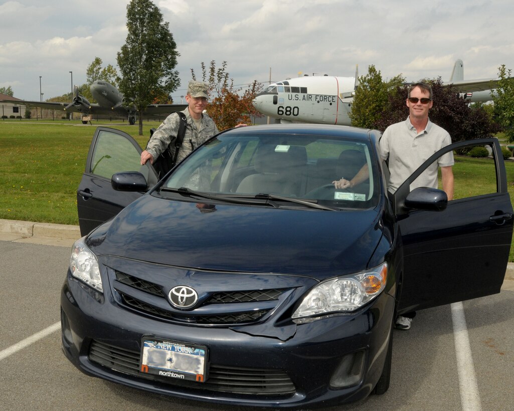 Carpooling to and from work. Master Sgt. Kevin Nichols (left), 914th Airlift Wing Public Affairs Non-Commissioned Officer In Charge and Mr. James Nagelhout, 914th Airlift Wing Environmental Protection Specialist get ready to go home at the end of their duty day on September 30, 2013 at the Niagara Falls Air Reserve Station, N.Y. Both Nichols and Nagelhout have been carpooling to work for the past three years. The two alternate driving different days of the week to work and home. (U.S. Air Force photo by Peter Borys)