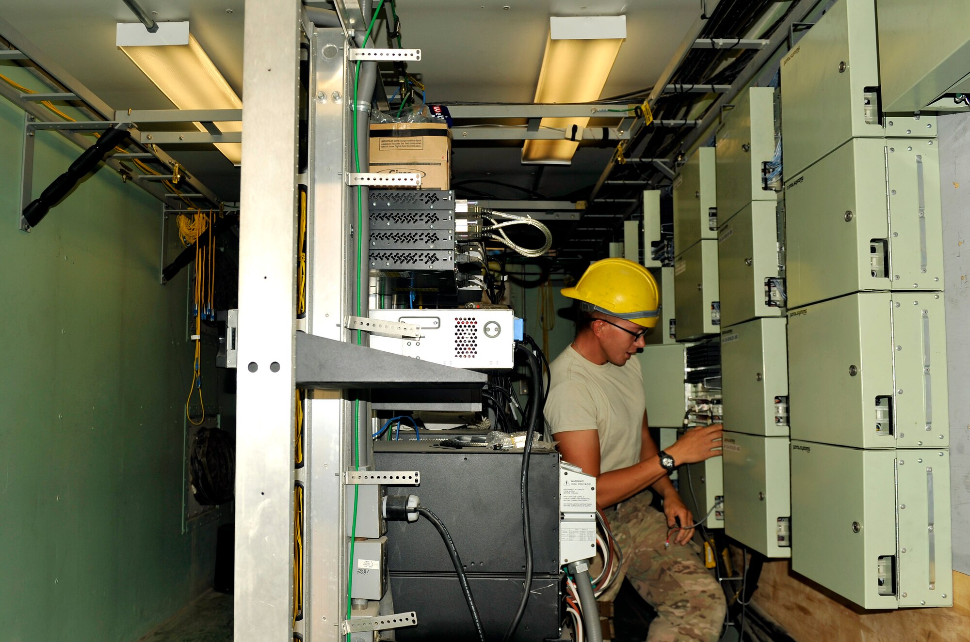 Senior Airman Eric Planthaber, 455th Expeditionary Communications Squadron engineering and installation journeyman, tests fiber cable in a network center on Bagram Airfield, Afghanistan, Sept. 12. He is deployed from Stewart Air National Guard Base, N.Y. (U.S. Air Force Photo/ Staff Sgt. Stephenie Wade)