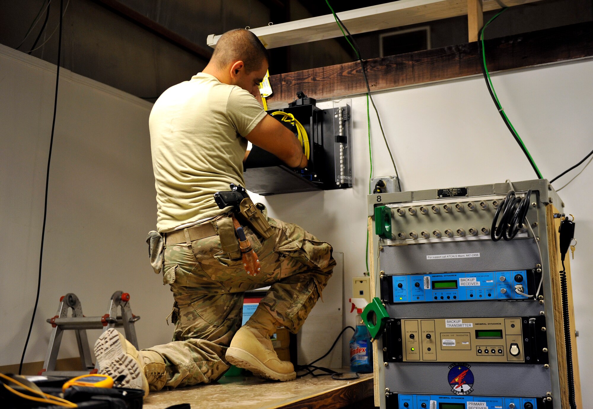 Airman 1st Class Kostikey, 455th Expeditionary Communications Squadron engineering and installation journeyman, installs fiber into a termination panel in the weather office on Bagram Airfield, Afghanistan, Sept. 12.  He is deployed from Stewart Air National Guard Base, N.Y. (U.S. Air Force Photo/ Staff Sgt. Stephenie Wade)