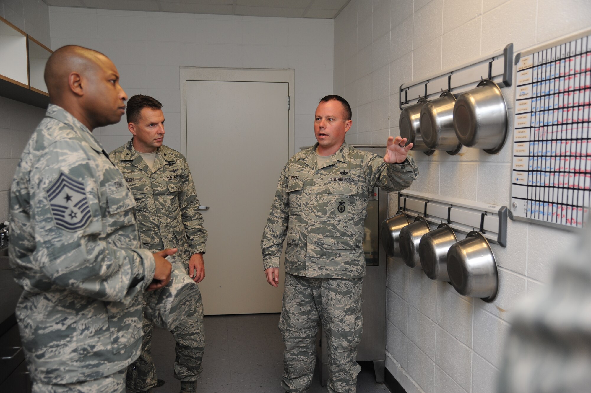 Chief Master Sgt. Farrell Thomas, 81st Training Wing command chief, and Brig. Gen. Patrick Higby, 81st TRW commander, are provided a tour of the 81st Security Forces military working dog kennels by Tech. Sgt. Christopher Perez, 81st SFS kennel master, Sept. 26, 2013, at Keesler Air Force Base, Miss.  The tour was a continuation of the 81st Mission Support Group immersion tour for Higby and Thomas.