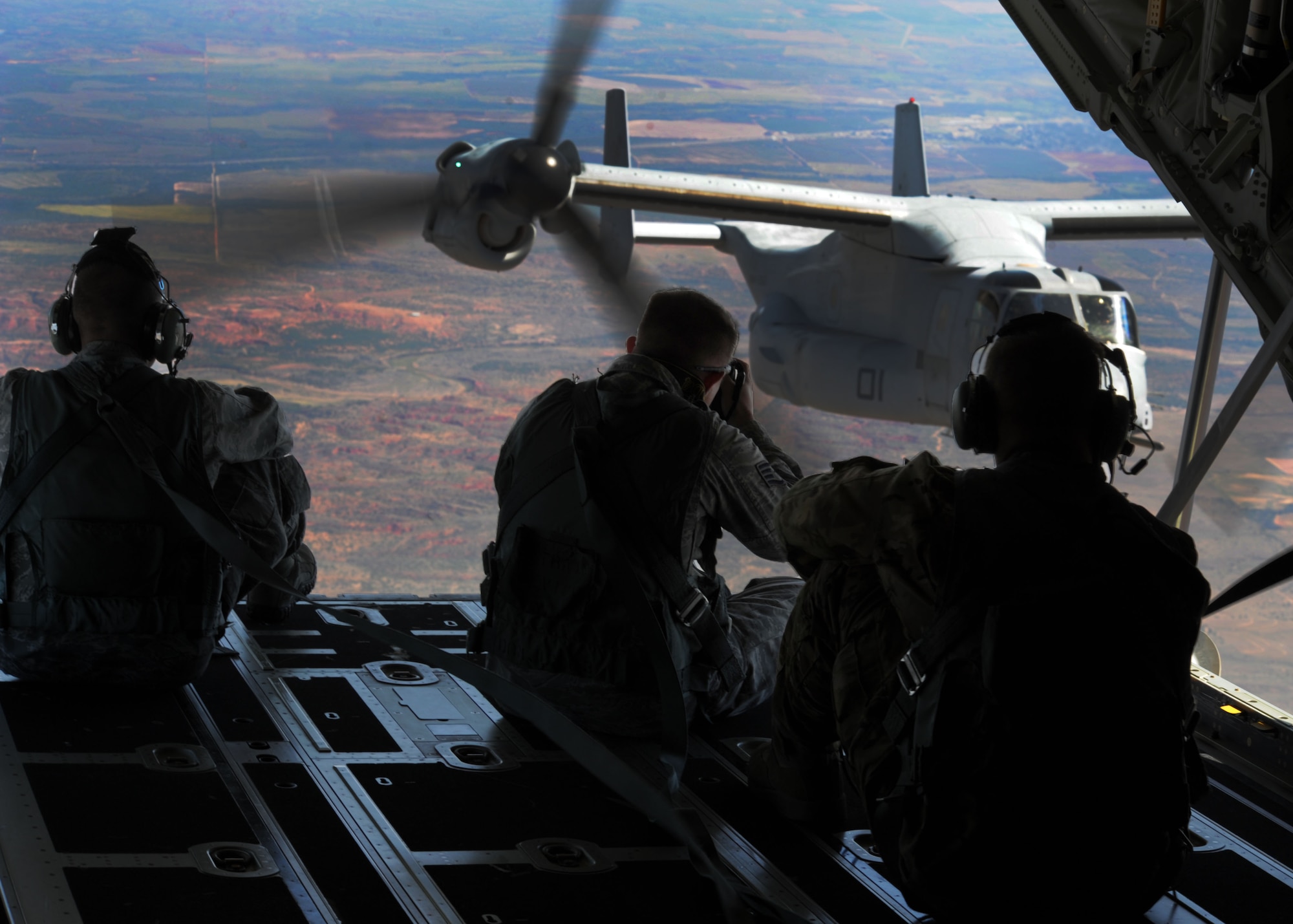 U.S. Air Force Staff Sgt. Matthew Plew, 27 Special Operations Wing  Public Affairs Office, photojournalist, documents a CV-22 Osprey as it refuels Sept. 26, 2013, over northern New Mexico. The Osprey flew as part of a joint training mission with the 522nd Special Operations Squadron and the 22nd Marine Expeditionary Unit. (U.S. Air Force photo/Senior Airman Ericka Engblom)