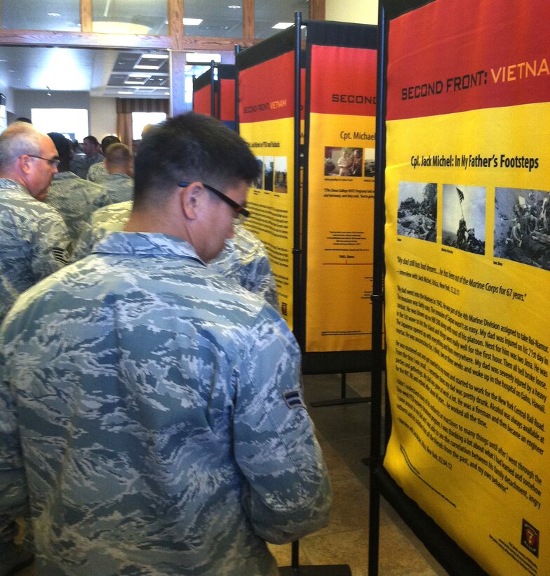 Members of the 914th Airlift Wing look over a temporary wall display put together by the Vietnam Veterans of America at the Niagara Falls Air Reserve Station, N.Y. September 8, 2013.  This traveling display tells of the stories and highlights the photos and other memorabilia of Vietnam Veterans as an outreach to current combat veterans.  (U.S. photo by Tech. Sgt. Andrew Caya)