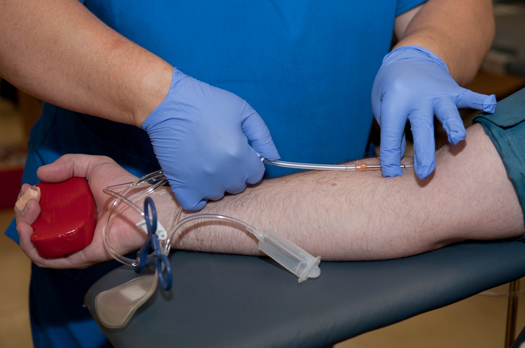 ALTUS AIR FORCE BASE, Okla. – Carol Demmel, Oklahoma Blood Institute phlebotomist, injects an intravenous needle into the arm of U.S. Air Force Staff Sgt. Jerome Duhan, 97th Communications Squadron systems administrator, during the Altus AFB blood drive inside the chapel activities room Sept. 27. Before the “sticking” process, the needle and point of puncture are sterilized to keep the donor from getting any infection. The Oklahoma Blood Institute is a local organization that collects and donates blood to more than 140 medical facilities in Oklahoma. (U.S. Air Force photo by Senior Airman Dillon Davis/Released)