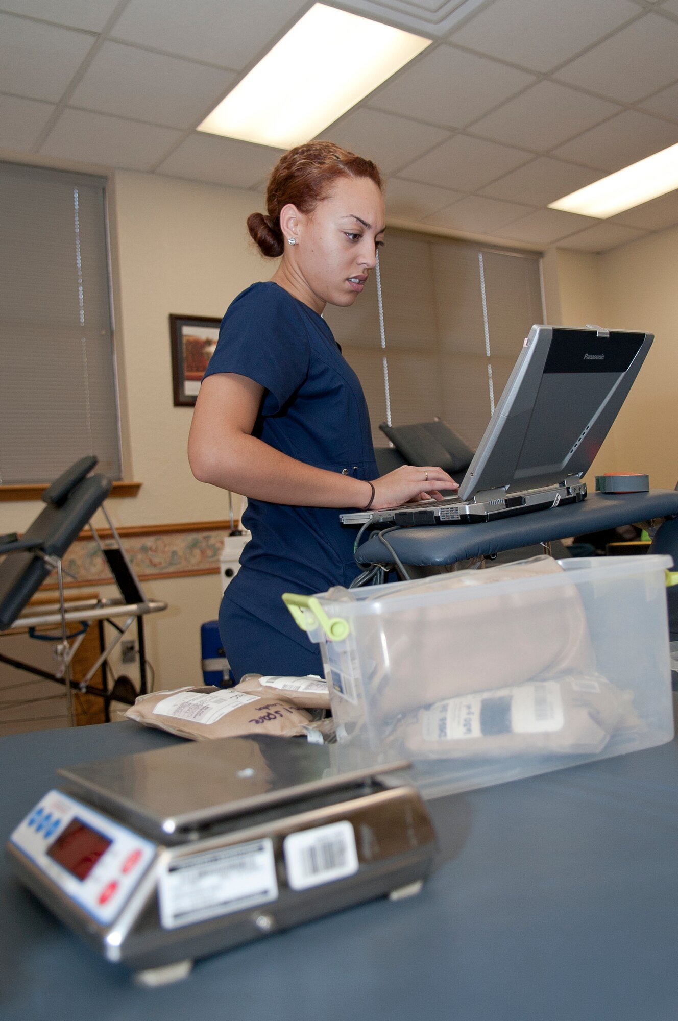 ALTUS AIR FORCE BASE, Okla. – Ashley Farler, Oklahoma Blood Institute phlebotomist, prepares blood drawing stations for the Altus AFB blood drive inside the chapel activities room Sept. 27. The stations must be thoroughly prepared before they can start drawing blood from donors. The Oklahoma Blood Institute is a local organization that collects and donates blood to more than 140 medical facilities in Oklahoma. (U.S. Air Force photo by Senior Airman Dillon Davis/Released)