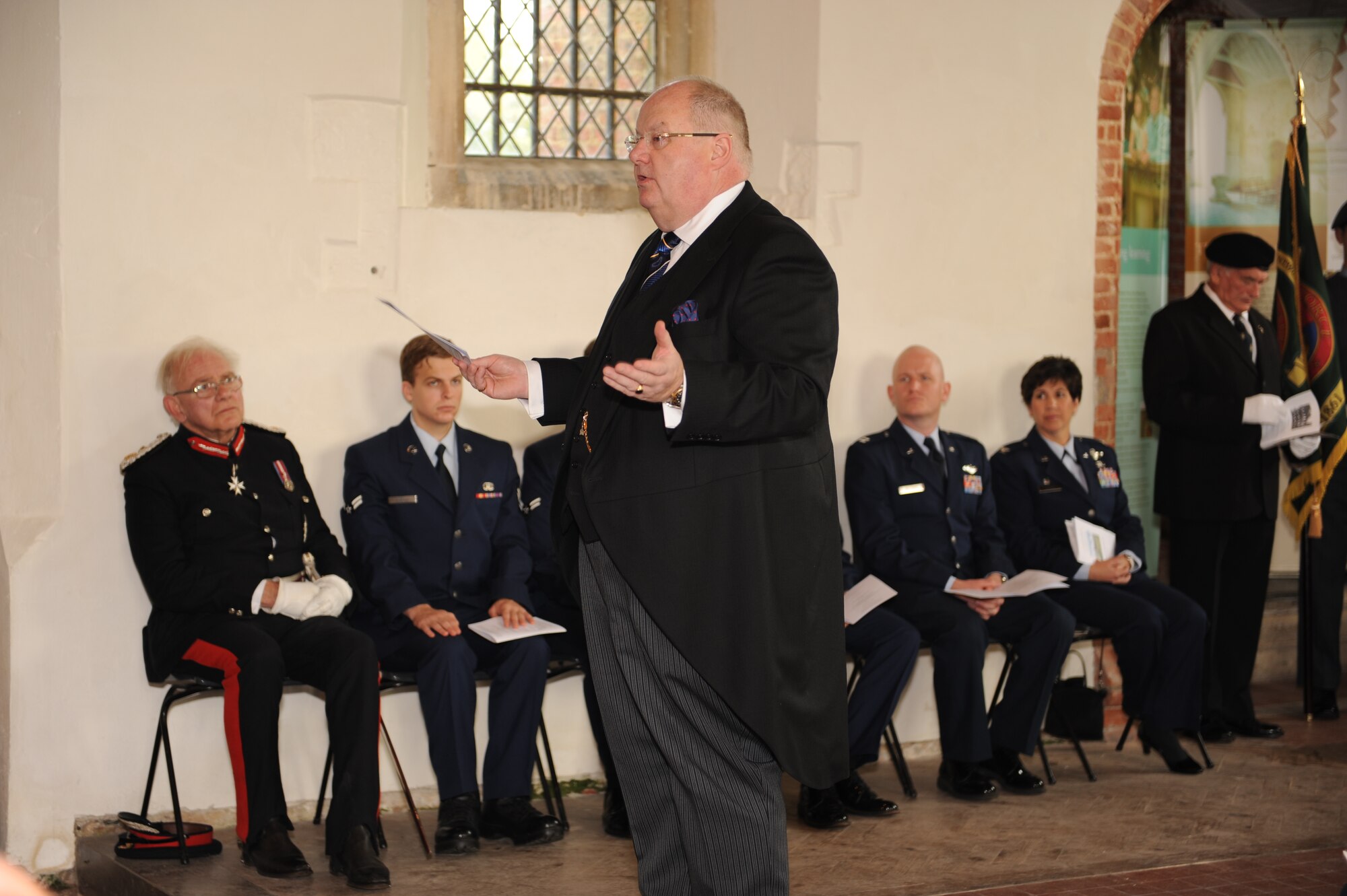 The Right Honorable Eric Pickles, Member of Parliament, thanks everyone who attended the remembrance service Sept. 28, 2013, at the Church of All Saints, East Horndon, England, of the Sept. 26, 1943, mid-air collision of two B-17 Flying Fortresses — Dorsal Queen and Raunchy Wolf. The collision killed 19 Americans who were returning to England following a bombing mission during World War II. Pickles, along with several others, laid a wreath near the front of the church to honor the deceased on its 70th anniversary. (U.S. Air Force photo by Airman 1st Class Preston Webb/Released)