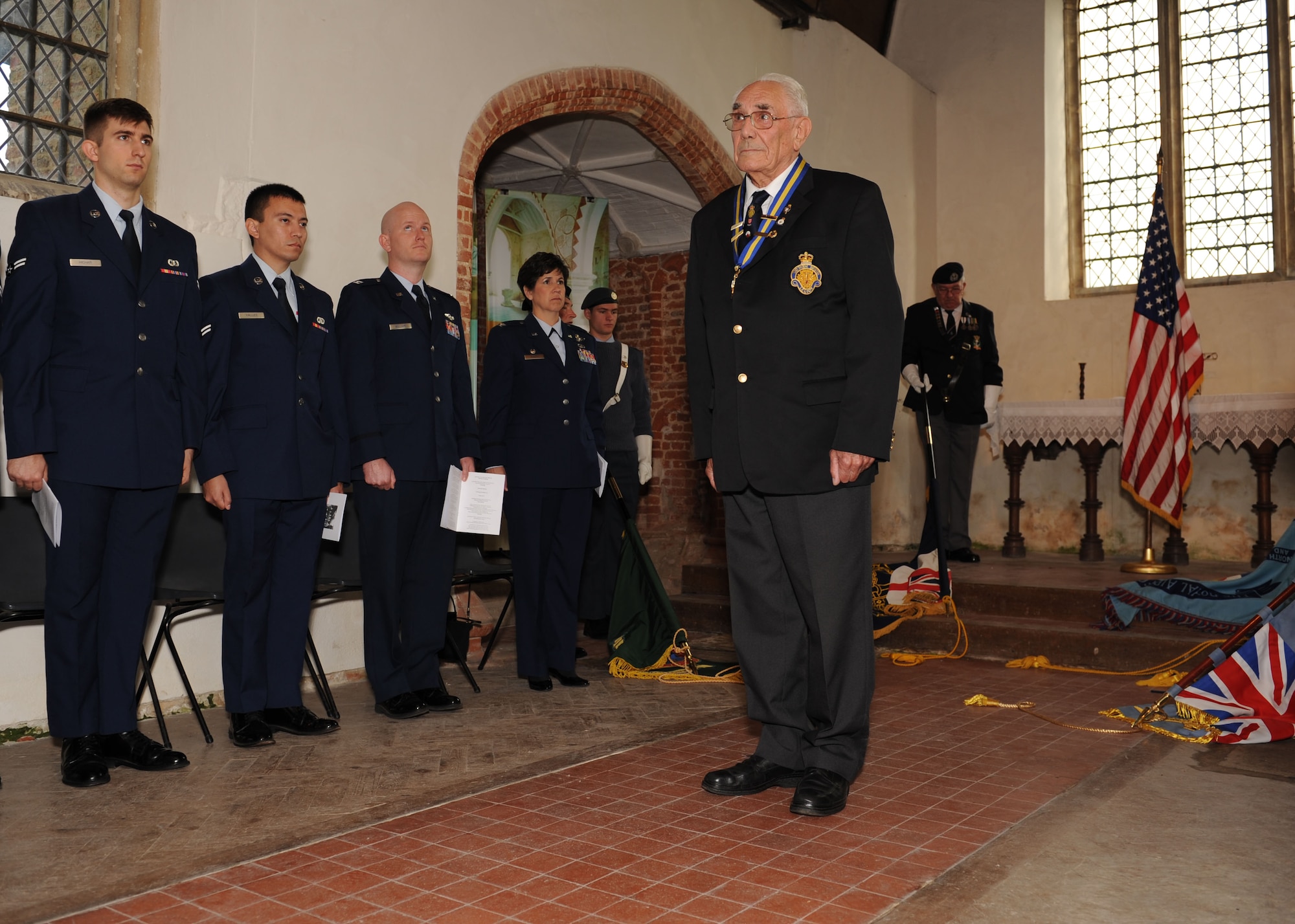 Brian Kitchener, Chairman, Royal British Legion, Brentwood, leads the audience in a few minutes of silence and remembrance during a commemoration service Sept. 28, 2013, at the Church of All Saints, East Horndon, England. The service commemorated the 70th anniversary of the Sept. 26, 1943, mid-air collision of two B-17 Flying Fortresses — Dorsal Queen and Raunchy Wolf — killing 19 Americans who were returning to England following a bombing mission during World War II. RAF Mildenhall Airmen attended the ceremony to honor the deceased. (U.S. Air Force photo by Airman 1st Class Preston Webb/Released)