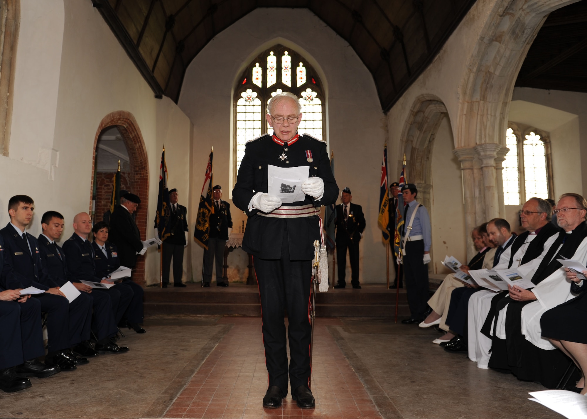 Lord Petre, Lord Lieutenant of Essex, provides a commemoration speech during a remembrance service Sept. 28, 2013, at the Church of All Saints, East Horndon, England. The service commemorated the 70th anniversary of the Sept. 26, 1943, mid-air collision of two B-17 Flying Fortresses — Dorsal Queen and Raunchy Wolf — killing 19 Americans returning to England following a bombing mission during World War II. Airmen assigned to RAF Mildenhall were invited to the ceremony to honor the deceased. (U.S. Air Force photo by Airman 1st Class Preston Webb/Released)