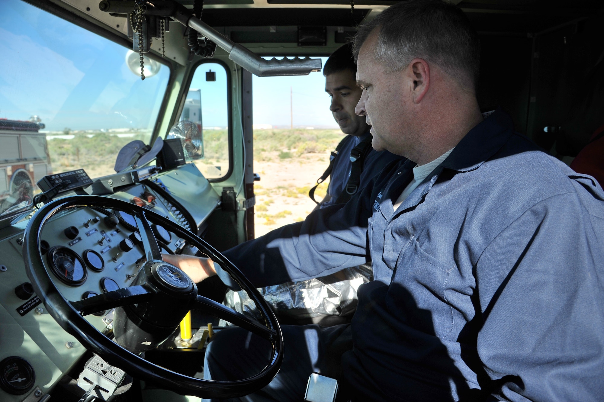 Col. Jeffrey Lanning, 377th Mission Support Group commander, learns to operate a fire fighting crash truck during a training exercise Sept. 20. (Photo by Ken Moore)