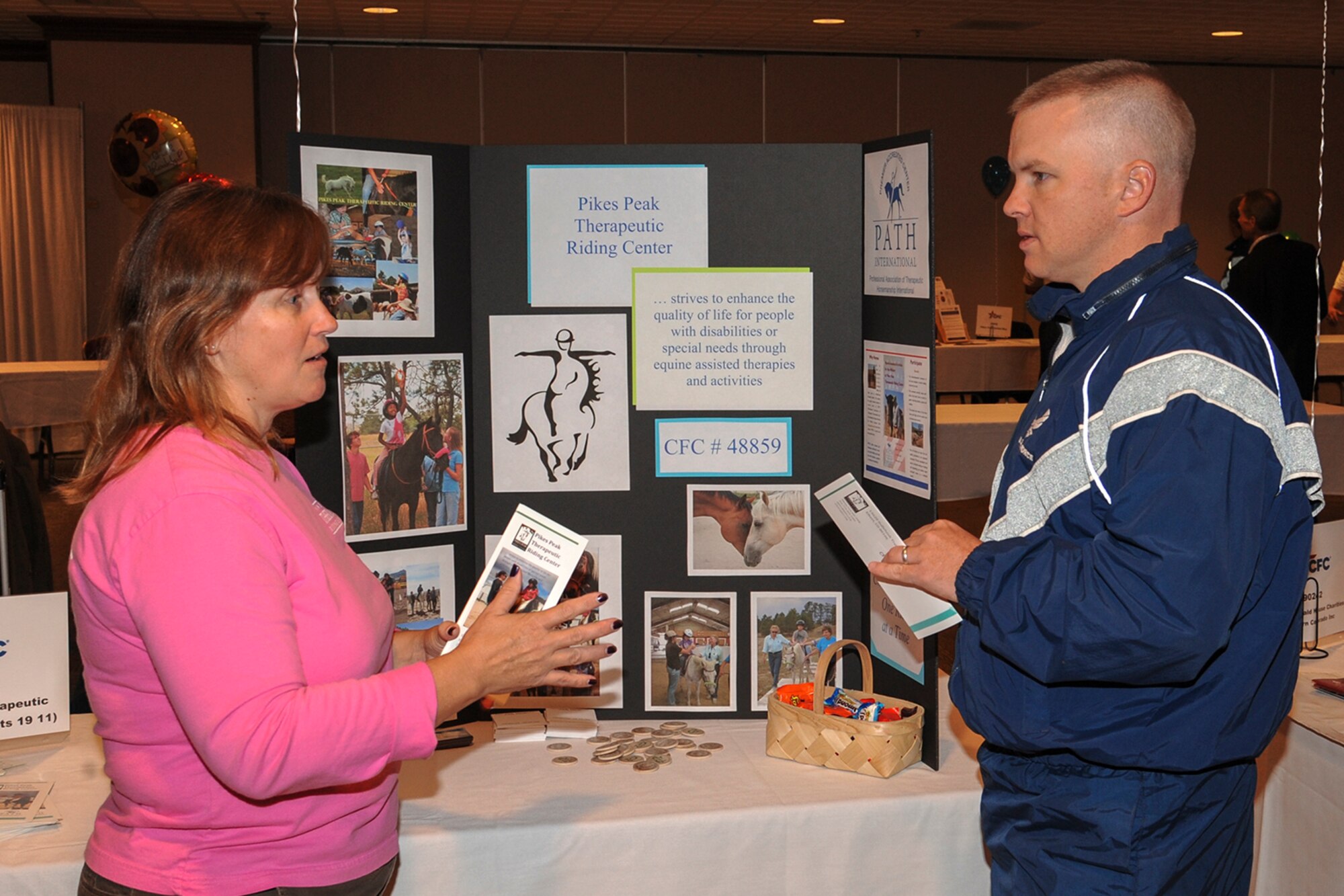 PETERSON AIR FORCE BASE, Colo. – Diane Eshelman discusses her organization's mission with Senior Master Sgt. Scott Westfall Sept. 24 at the Club during the Combined Federal Campaign kickoff event. The goal of the CFC is to promote and support philanthropy through a program that is employee-focused, cost-efficient, and effective in providing all federal employees the opportunity to improve the quality of life for all. The CFC is the world’s largest and most successful annual workplace charity campaign, and one way for Team Pete to give back to the community. The CFC’s theme for 2013 is “It’s not about the goal, it’s about the need.” The annual fundraising campaign runs through Dec. 15. For information, go to www.peakcfc.com. (U.S. Air Force photo/Philip Carter)
