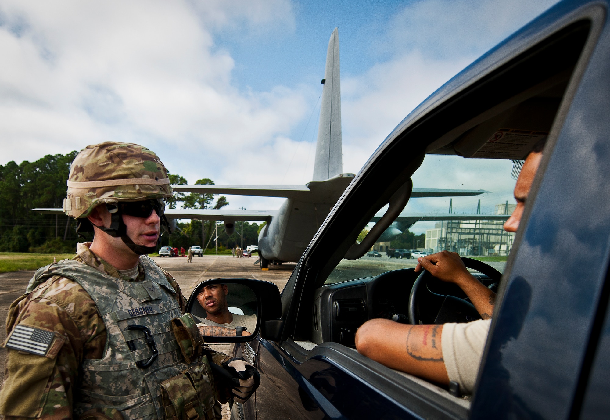 Senior Airman Michael Gessner, of the 633rd Security Forces Squadron, speaks with a “local” aircraft maintainer in a scenario during a Fly Away Security Team training session Sept. 26 at Eglin Air Force Base, Fla. The course, taught by 96th Ground Combat Training Squadron instructors, brought together security forces Airmen from both stateside and overseas to learn how to protect aircraft and handle a potential hostile situation. (U.S. Air Force photo/Samuel King Jr.)