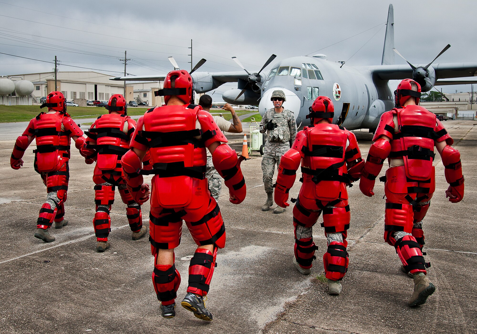A group of hostile villagers approach an American aircraft in an enemy attack scenario during a Fly Away Security Team training session Sept. 26 at Eglin Air Force Base, Fla. The course, taught by 96th Ground Combat Training Squadron instructors, brought together security forces Airmen from both stateside and overseas to learn how to protect aircraft and handle a potential hostile situation. (U.S. Air Force photo/Samuel King Jr.)