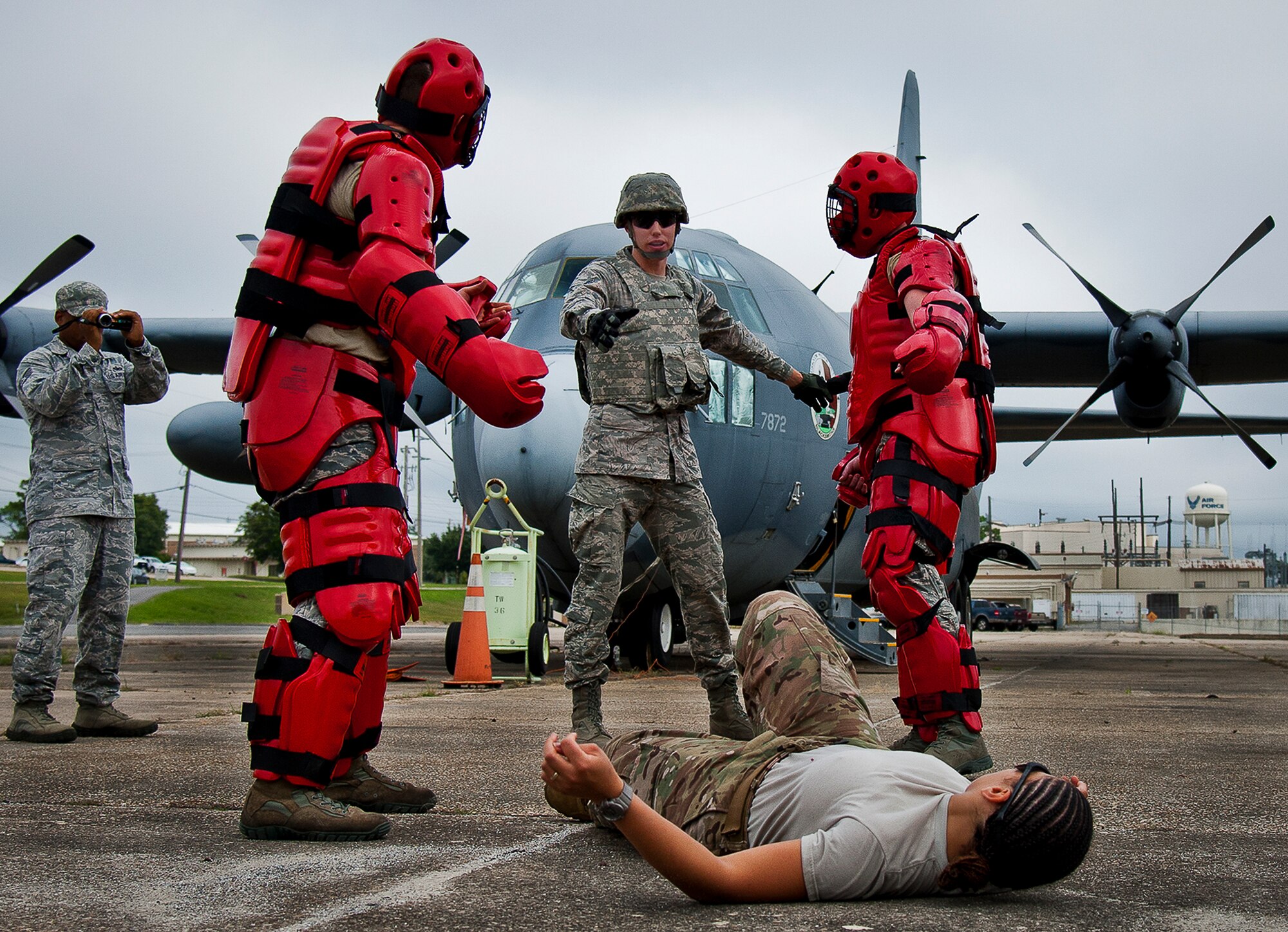 “Local” villagers bring an injured woman to a security forces Airman demanding medical care in a scenario during a Fly Away Security Team training session Sept. 26 at Eglin Air Force Base, Fla. The course, taught by 96th Ground Combat Training Squadron instructors, brought together security forces Airmen from both stateside and overseas to learn how to protect aircraft and handle a potential hostile situation. (U.S. Air Force photo/Samuel King Jr.)