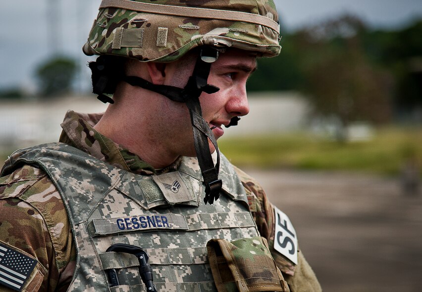 Senior Airman Michael Gessner, of the 633rd Security Forces Squadron, listens to a debrief after an enemy attack scenario during a Fly Away Security Team training session Sept. 26 at Eglin Air Force Base, Fla. The course, taught by 96th Ground Combat Training Squadron instructors, brought together security forces Airmen from both stateside and overseas to learn how to protect aircraft and handle a potential hostile situation. (U.S. Air Force photo/Samuel King Jr.)