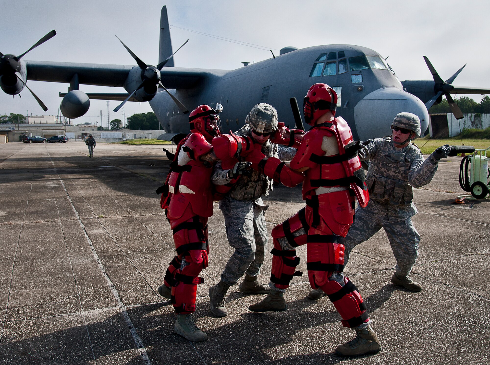 Enemy combatants in protective suits attack security forces Airmen guarding an aircraft during a Fly Away Security Team training session Sept. 26 at Eglin Air Force Base, Fla. The course, taught by 96th Ground Combat Training Squadron instructors, brought together security forces Airmen from both stateside and overseas to learn how to protect aircraft and handle a potential hostile situation. (U.S. Air Force photo/Samuel King Jr.)