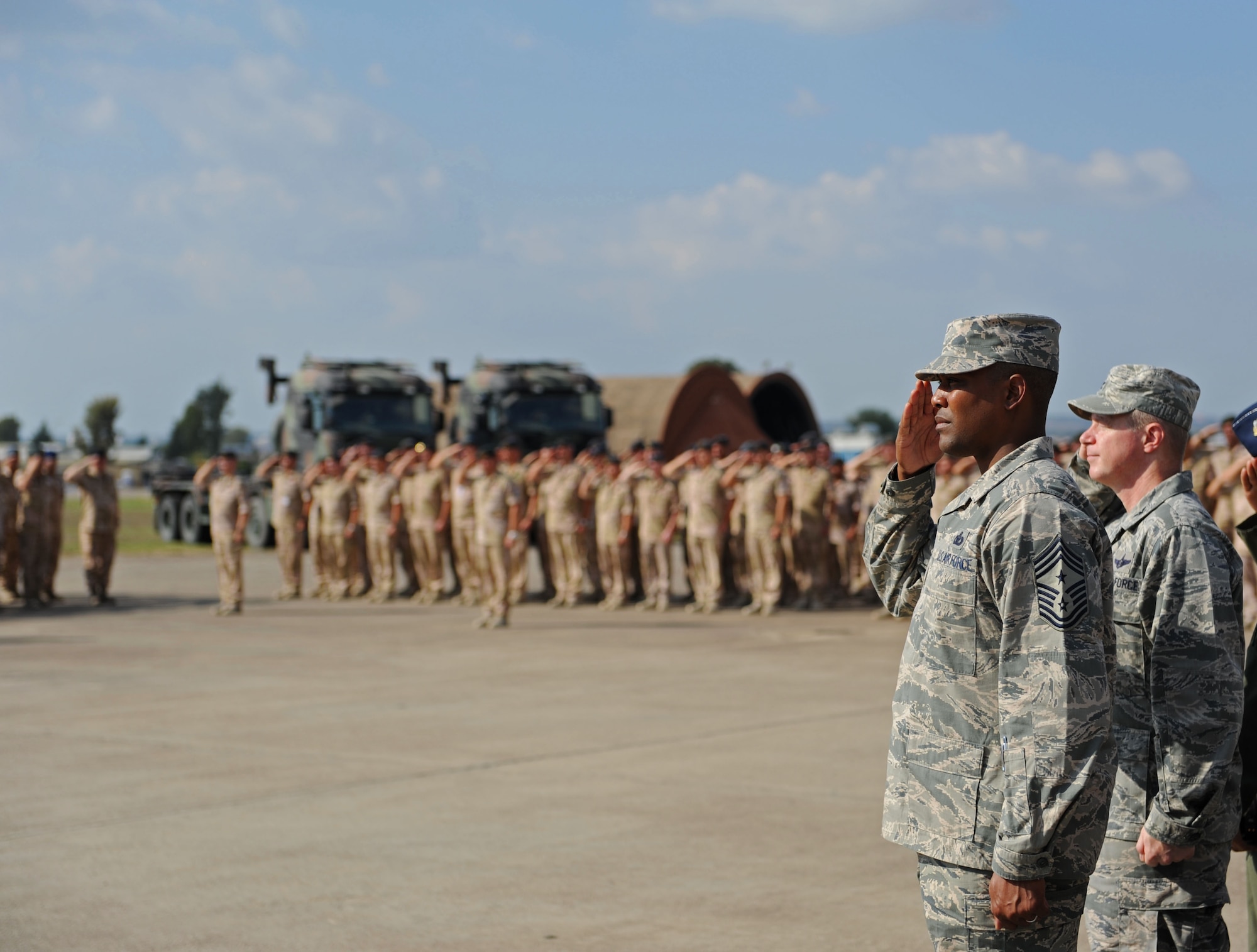 Chief Master Sgt. Anthony Johnson, 39th Air Base Wing command chief, and Col. Brent Bigger, 39th ABW vice commander, salute during the Netherland national anthem while attending the  Dutch army 1st Netherlands Ballistic Missile Defense Task Force change of command ceremony Sept. 27, 2013, at Incirlik Air Base, Turkey. The Dutch Patriot system has provided over 5,853 hours of air defense to the city of Adana, Turkey, since being declared operational on Jan. 26, 2013. (U.S. Air Force photo by Senior Airman Chase Hedrick/Released)
