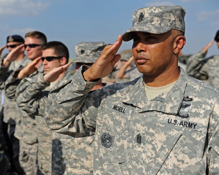 Army Command Sgt. Major Perry McNeill, 3rd Battalion, 2nd Air Defense Artillery command sergeant major, salutes alongside U.S. Airmen and coalition forces during a the Dutch army 1st Netherlands Ballistic Missile Defense Task Force change of command ceremony Sept. 27, 2013, at Incirlik Air Base, Turkey. German, Turkish and U.S. military leaders attended the ceremony as guests of the 1st NBMDTF. (U.S. Air Force photo by Senior Airman Chase Hedrick/Released)