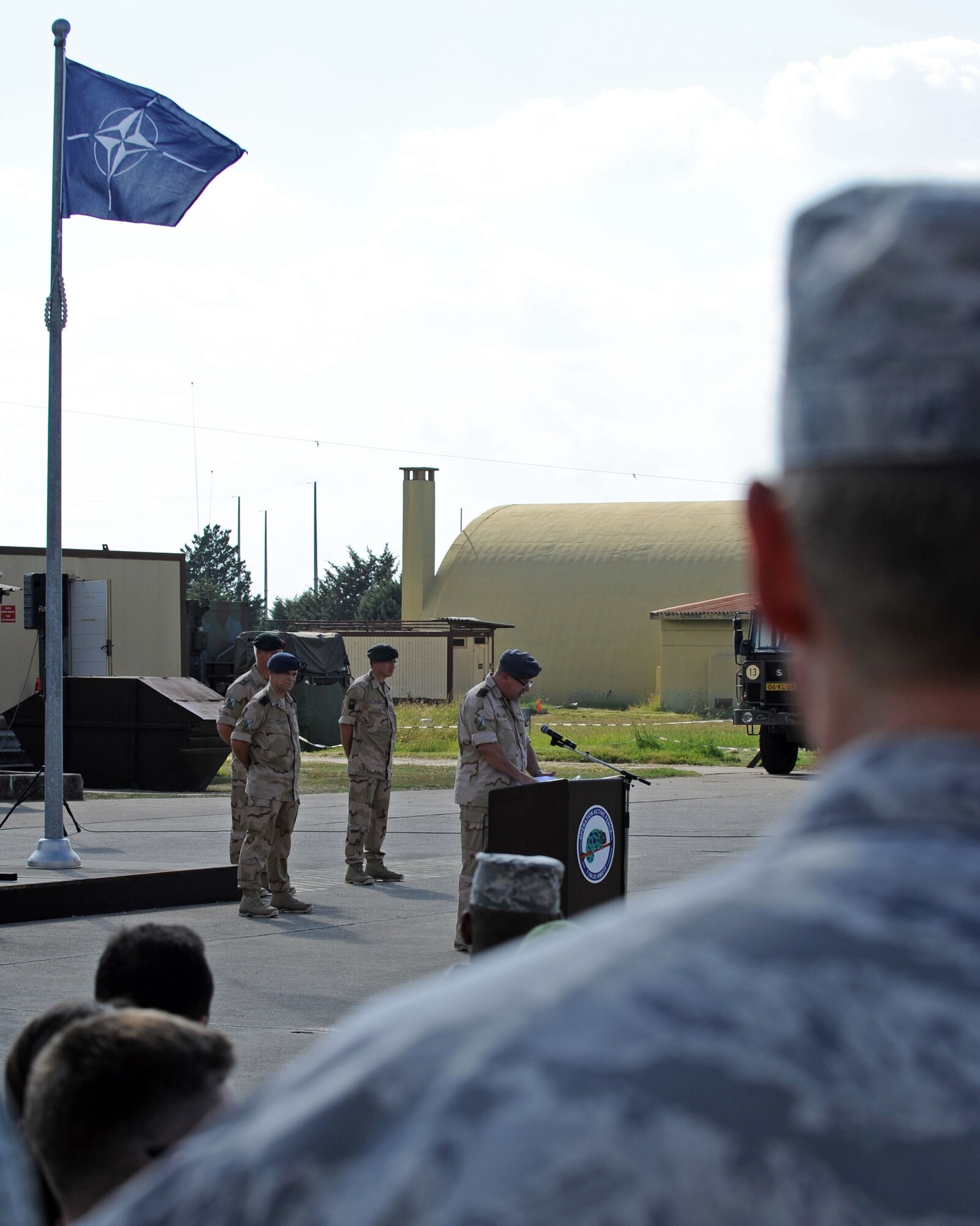 An Airman looks on as Dutch army Col. Peter Koning, outgoing 1st Netherlands Ballistic Missile Defense Task Force commander, offers his closing remarks during a change of command ceremony Sept. 27, 2013, at Incirlik Air Base, Turkey. The Dutch army invited German, Turkish and U.S. military leaders to attend the ceremony. (U.S. Air Force photo by Senior Airman Chase Hedrick/Released)